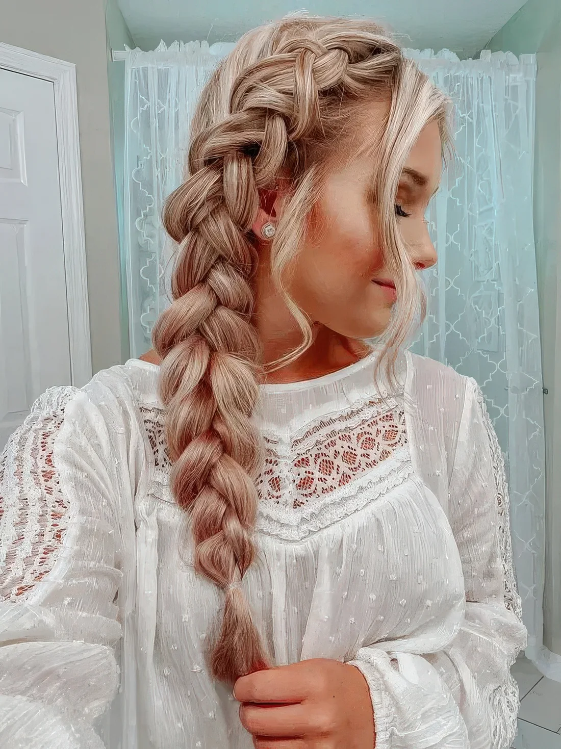 Chunky side braid and face-framing hair.
