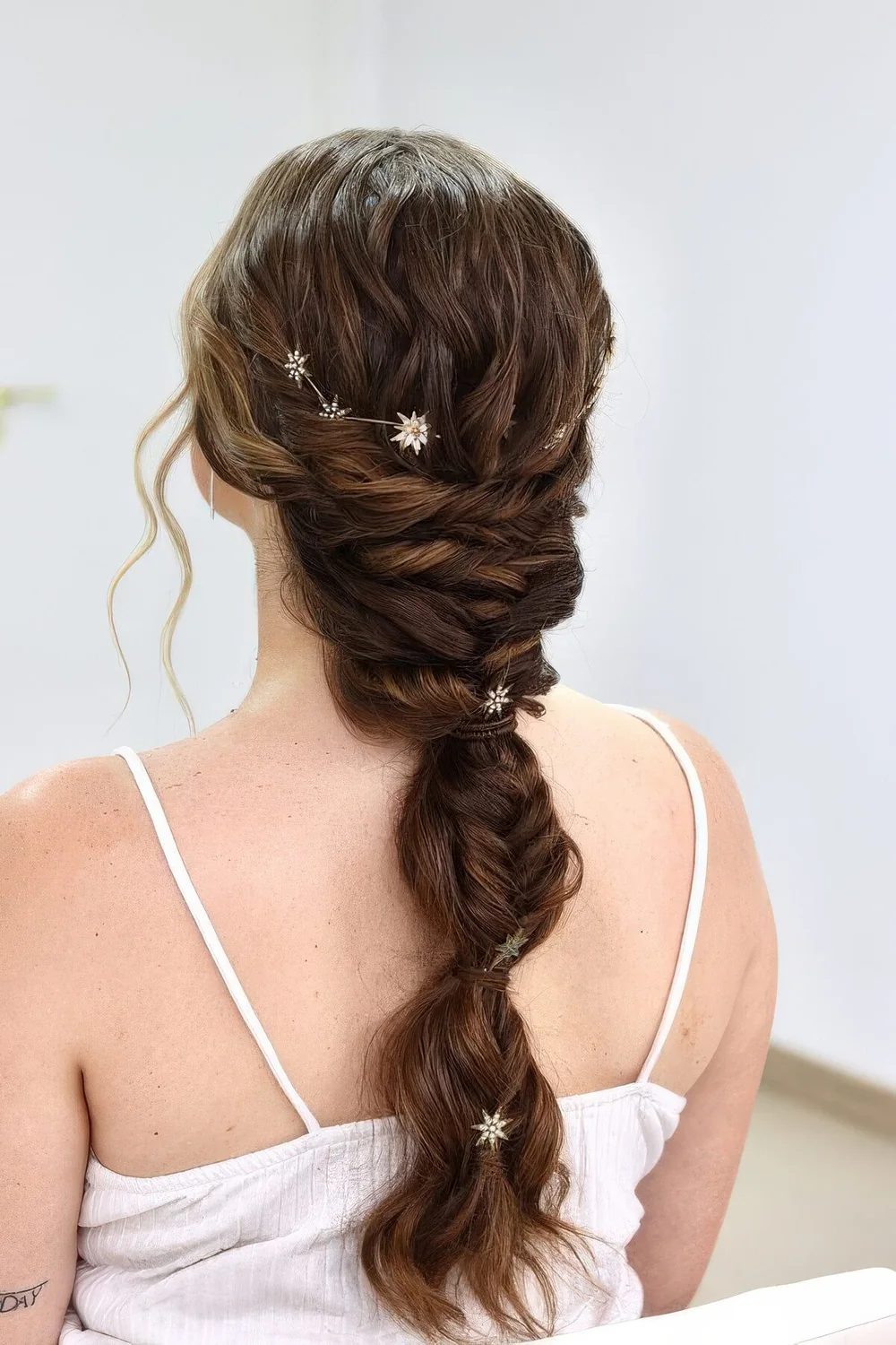 Creative wedding braid with twists and ponytail touches, a celestial vine and some star hair pins.