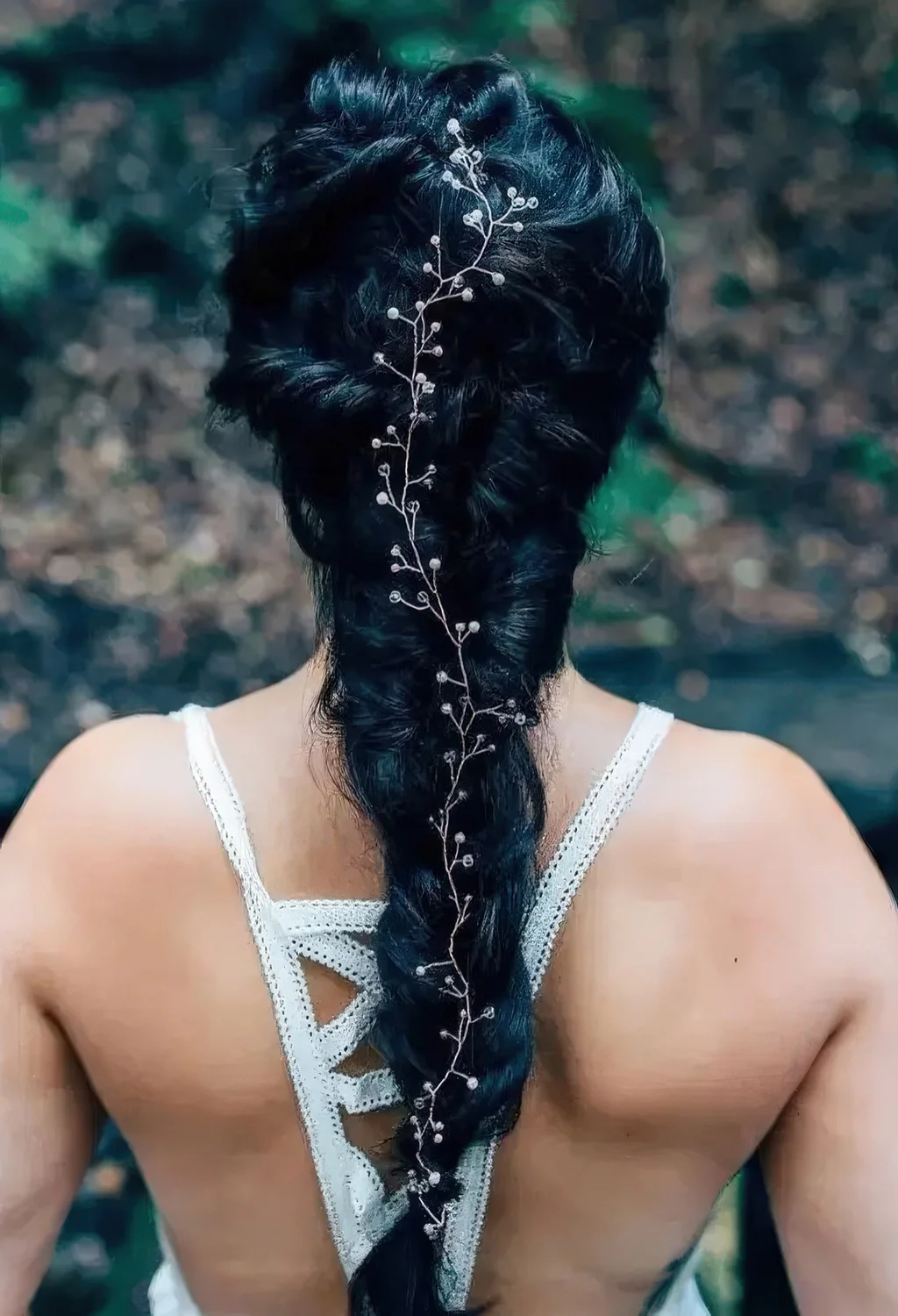 Twisted black braid with a lovely hair vine to accent it.