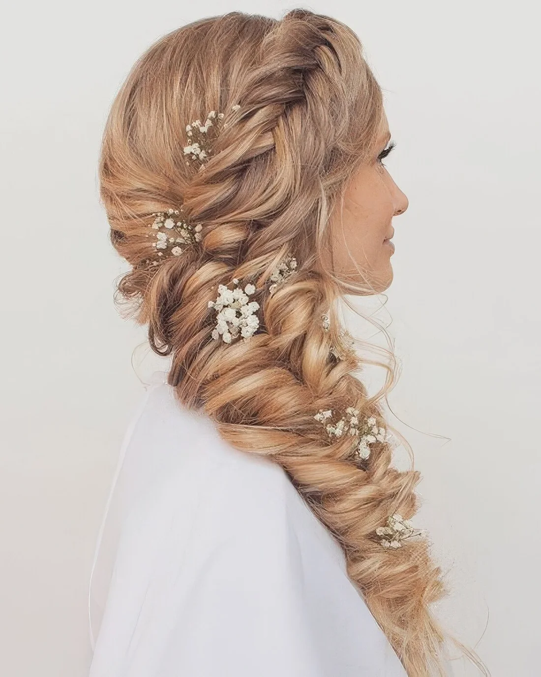 Large twisted side braid with a braided top and baby's breath.