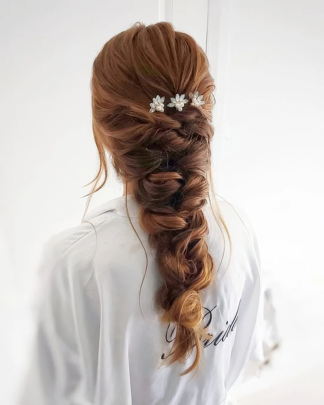 Loose and thick braid with twists and some flowers.