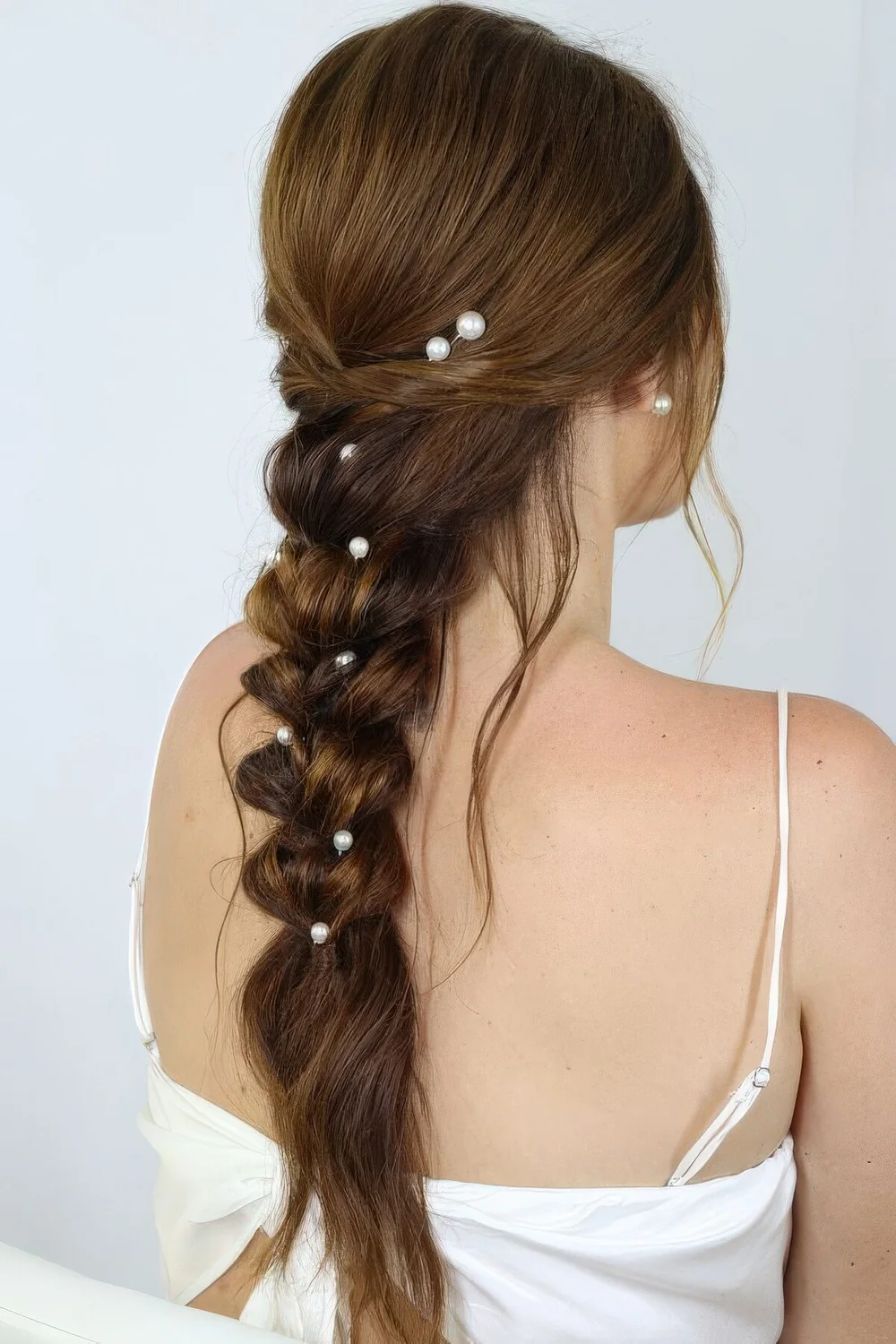 Photo showing hairstyle with pearl pins, with the hairstyle clearly visible.