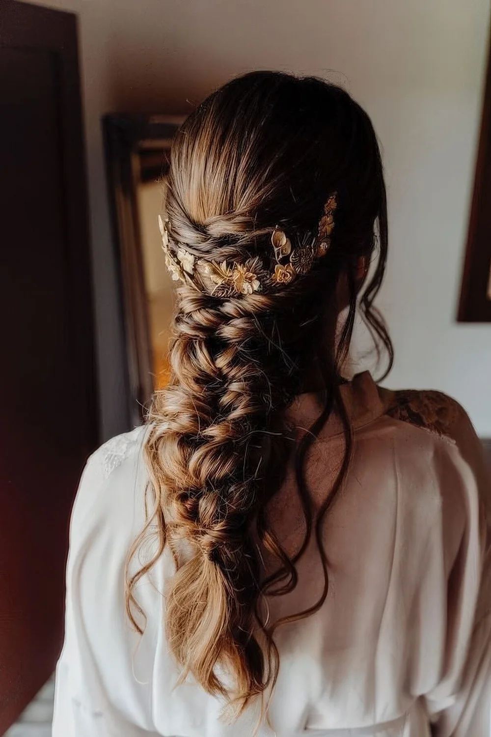 Loose twisted braid with twisted halos and some hair down, a gold hair vine are a lovely combo for a wedding.