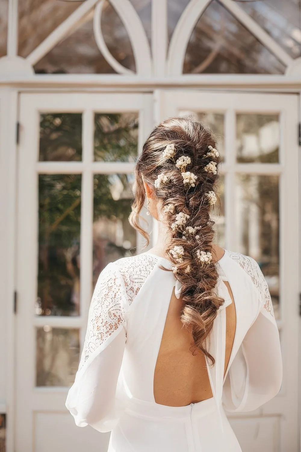 Loose twisted braid with white baby's breath blooms.