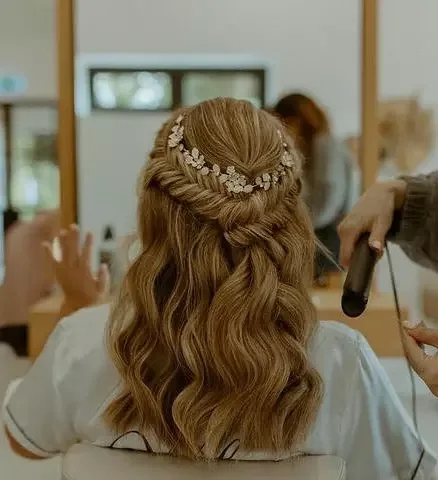 chest wavy blonde ponytail shown as a wedding guest hairstyle idea