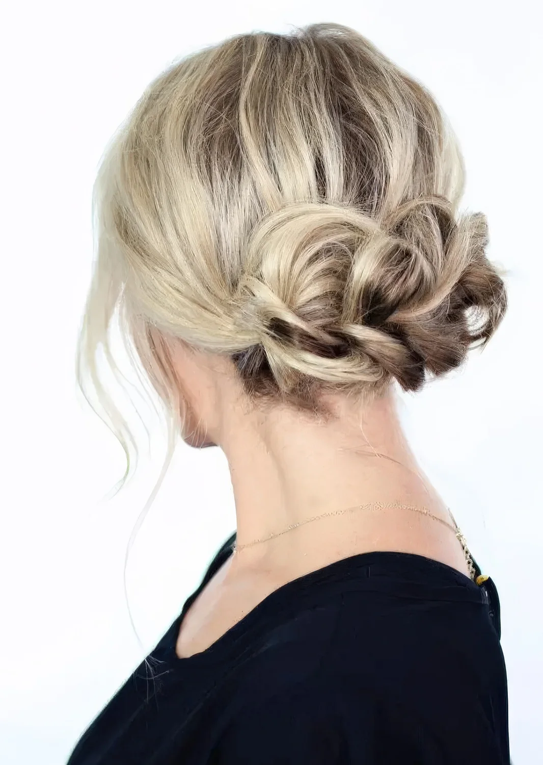 Braided low updo with some volume on top and some locks down.