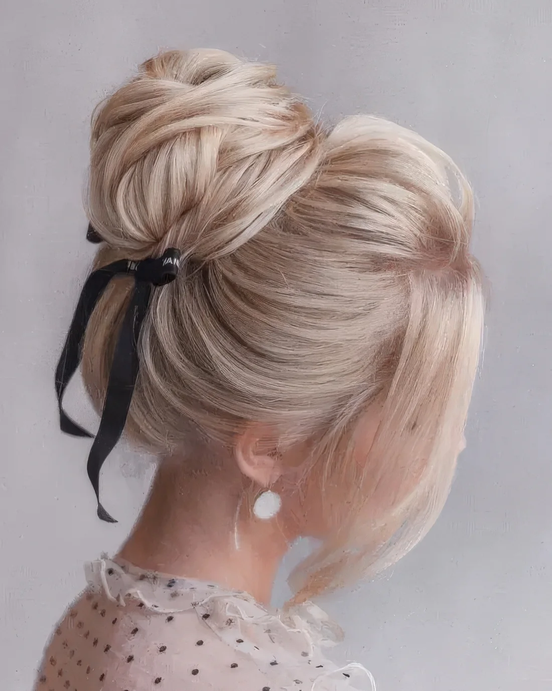 Wrapped top knot with a bump on top and face-framing hair plus a black ribbon bow for a trendy touch.