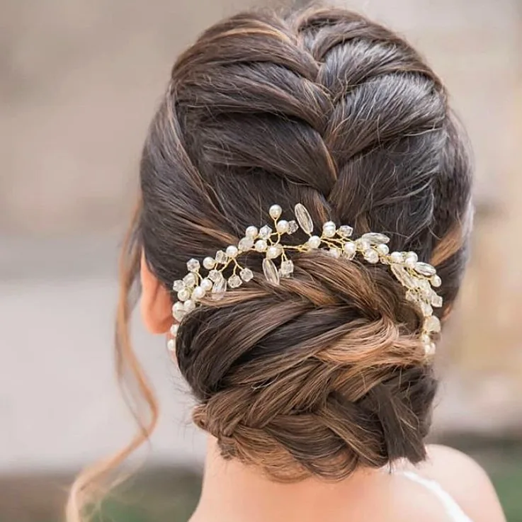 chest wavy brunette updo shown as a wedding hairstyles ideas for long hair idea, featuring wavy texture