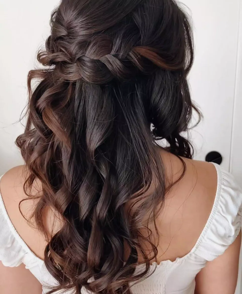 chest straight black ponytail shown as a wedding hairstyles ideas for long hair idea