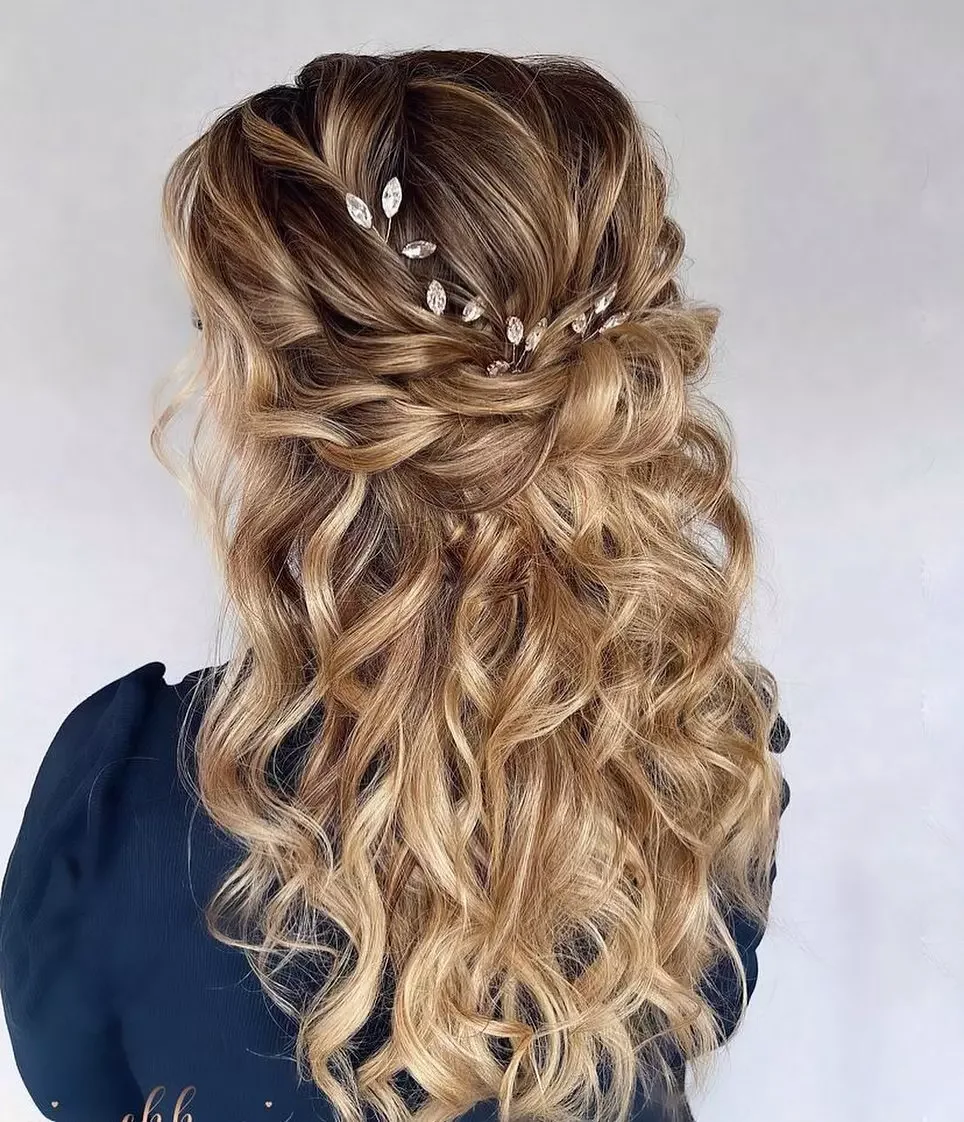 chest wavy brunette ponytail shown as a wedding hairstyles ideas for long hair idea