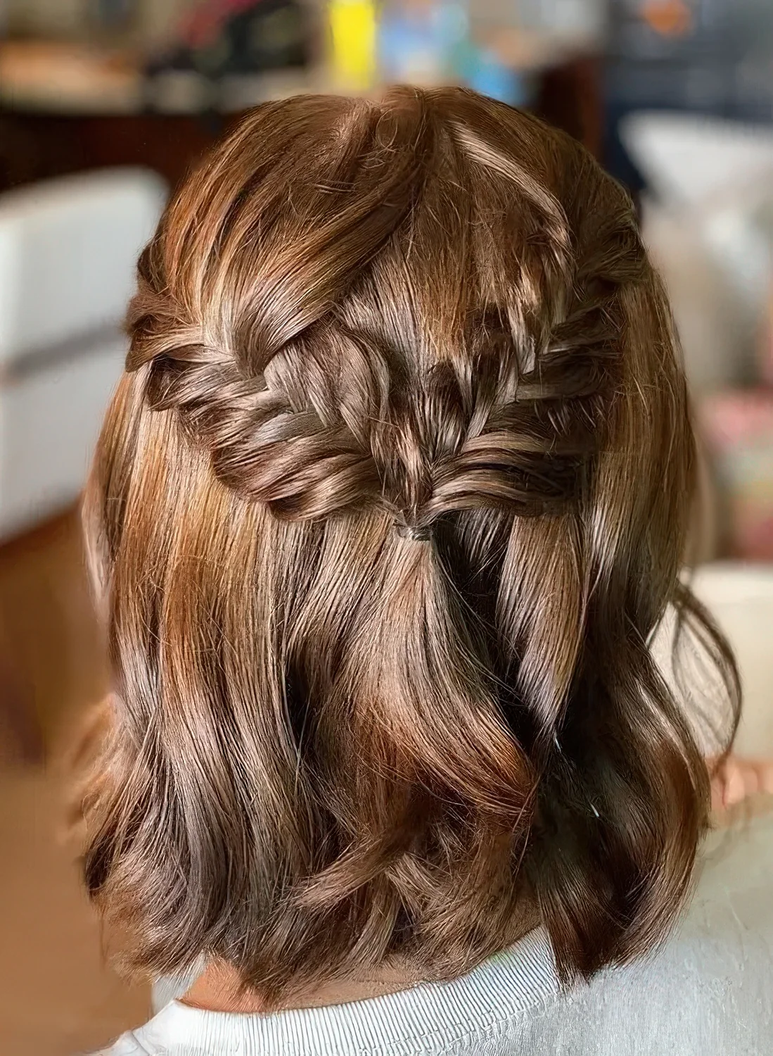 Medium half updo with a fishtail braid halo and waves down.