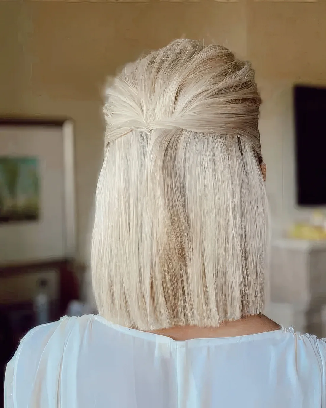 Blonde medium-length half updo with a textured top and straight hair down.