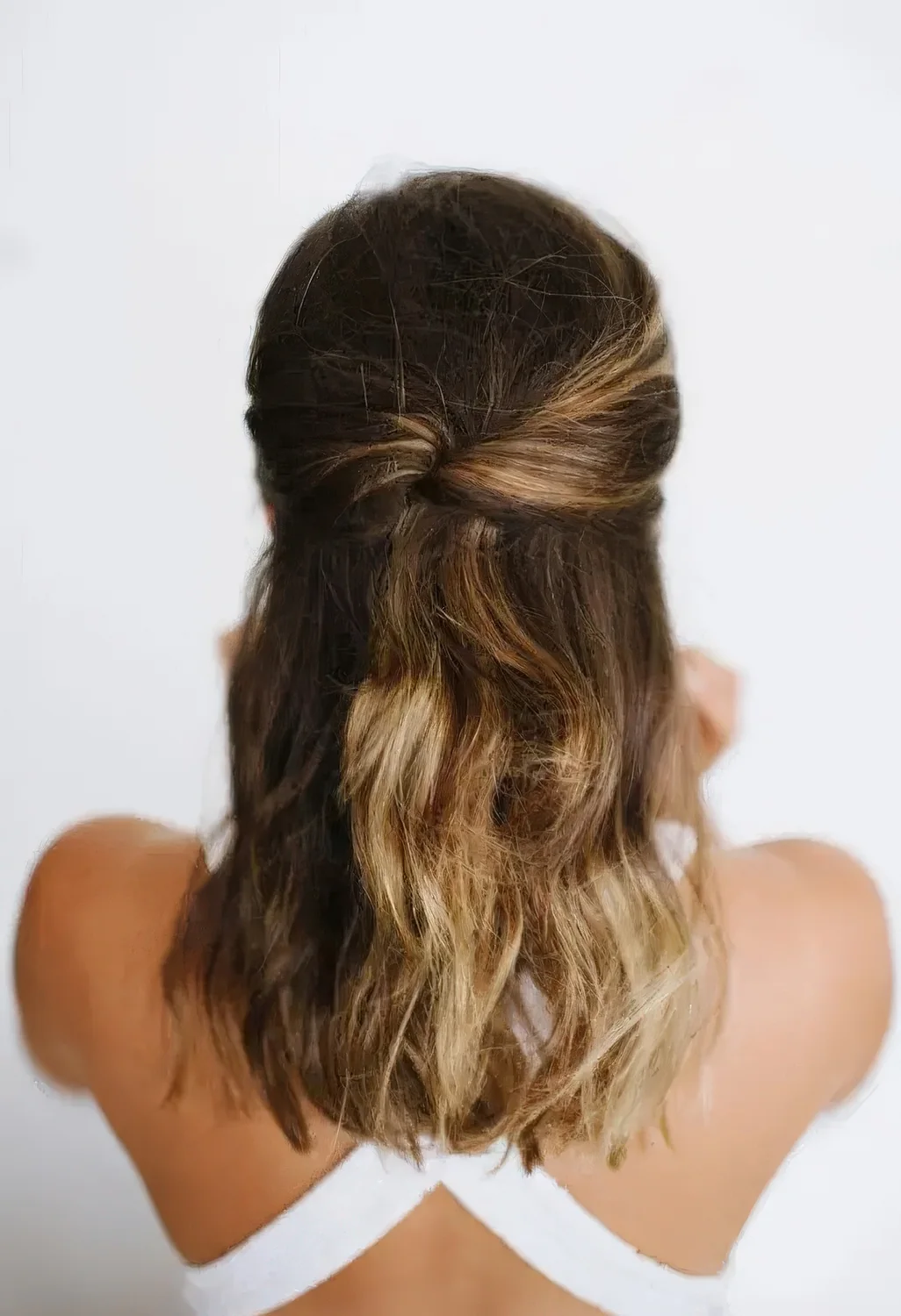 Half updo with a bump on top, twists and waves down.