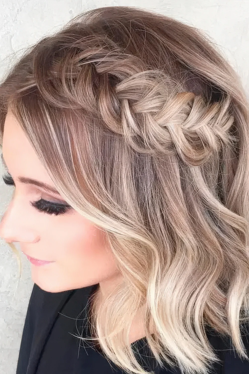 Chic half updo with a loose braid and hair down.