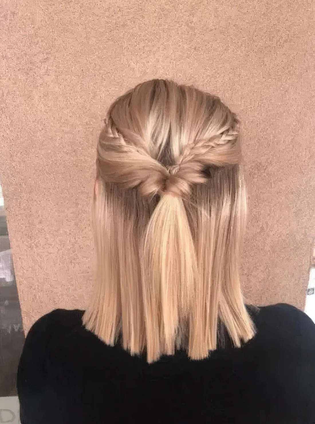 Half updo with a bump, twists and small braids and straightened hair down.