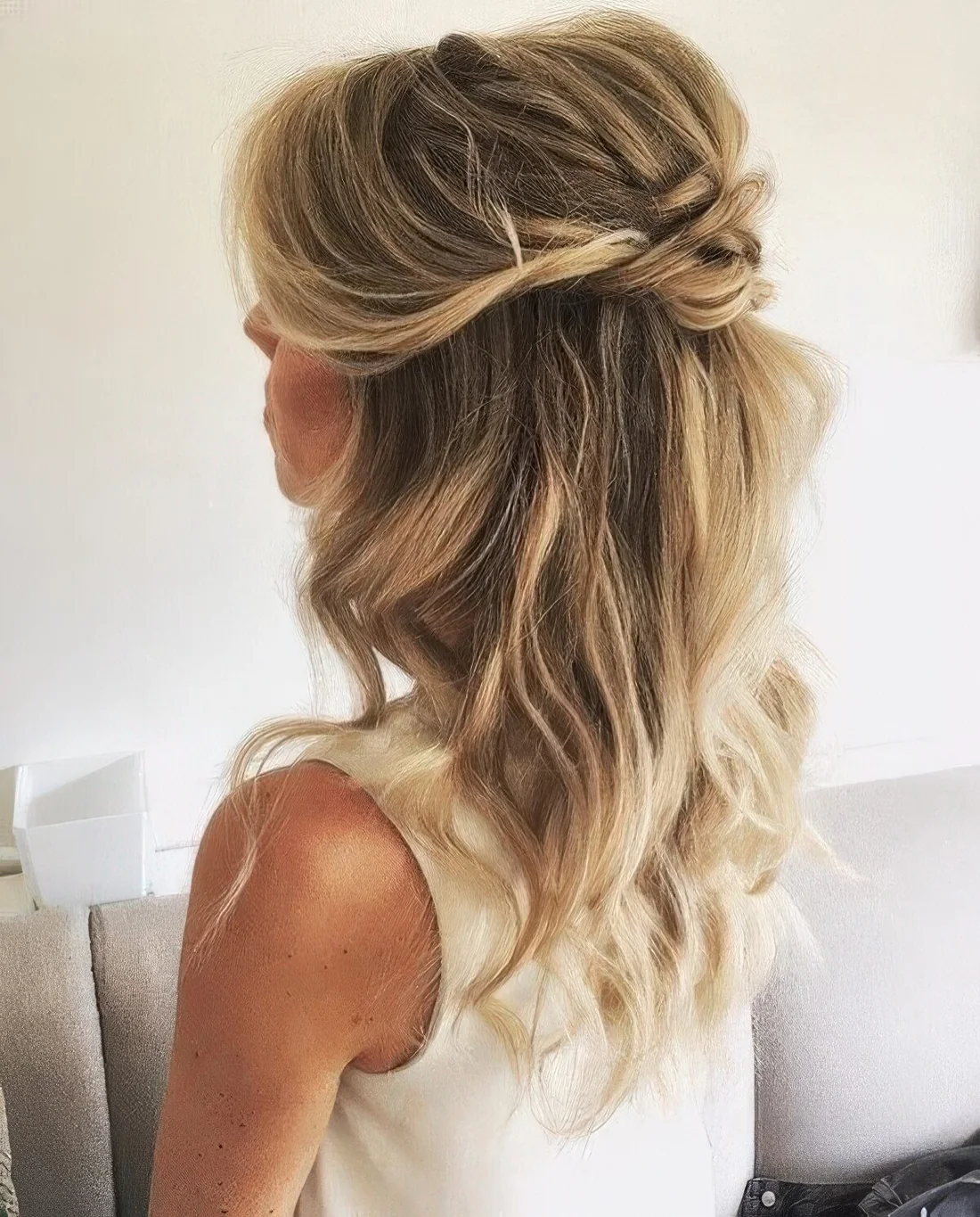 Wedding half updo with a bump on top, some twsists and waves down.
