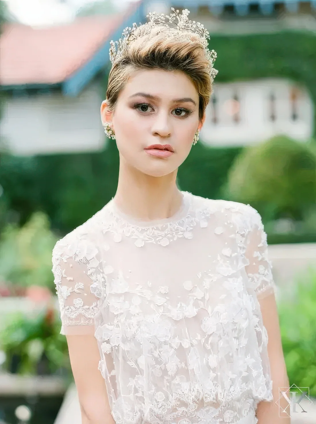 Dimensional pixie haircut with caramel balayage and a rhinestone tiara.