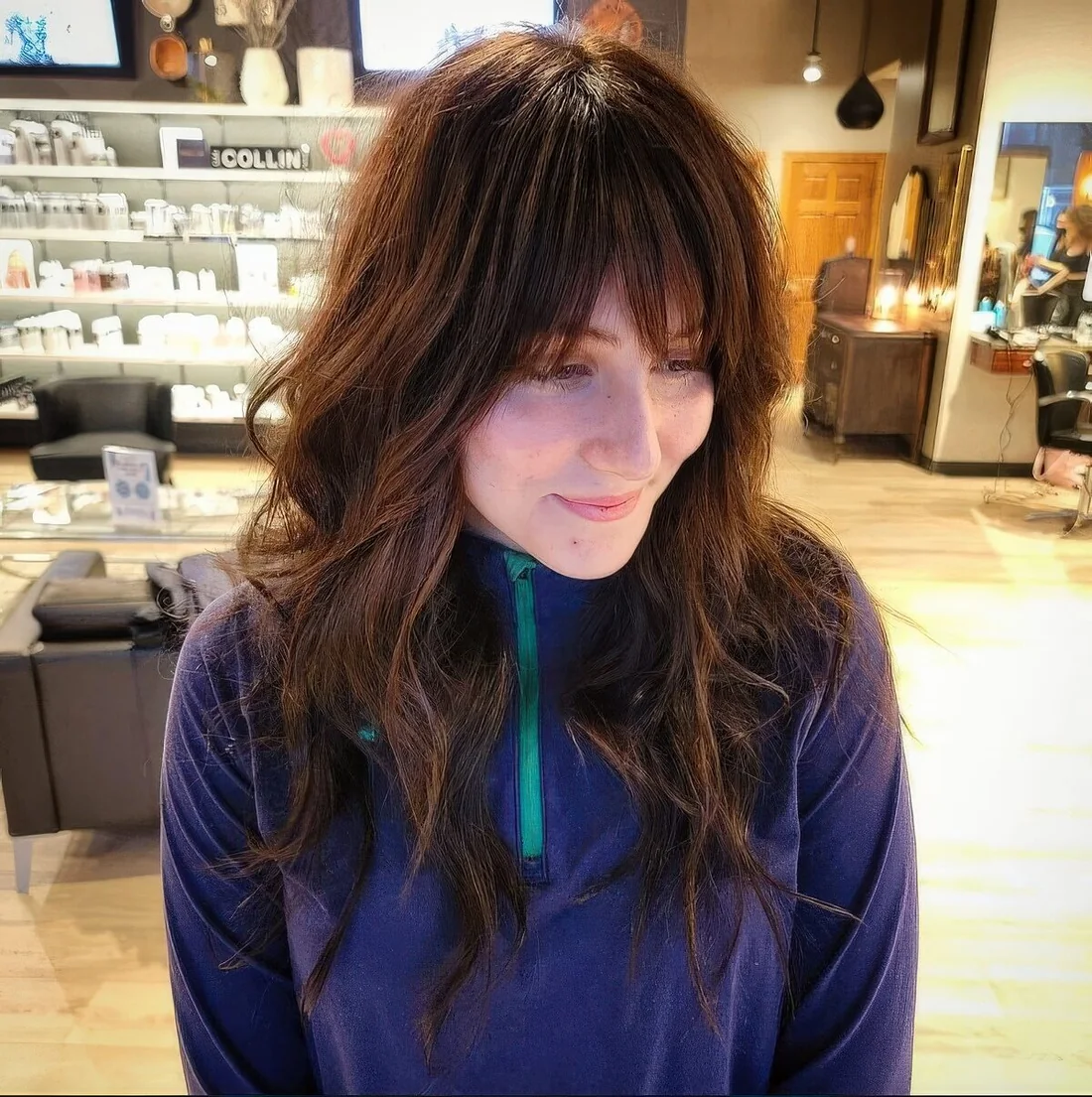 Rich brown long wolf cut with wispy bangs and waves.