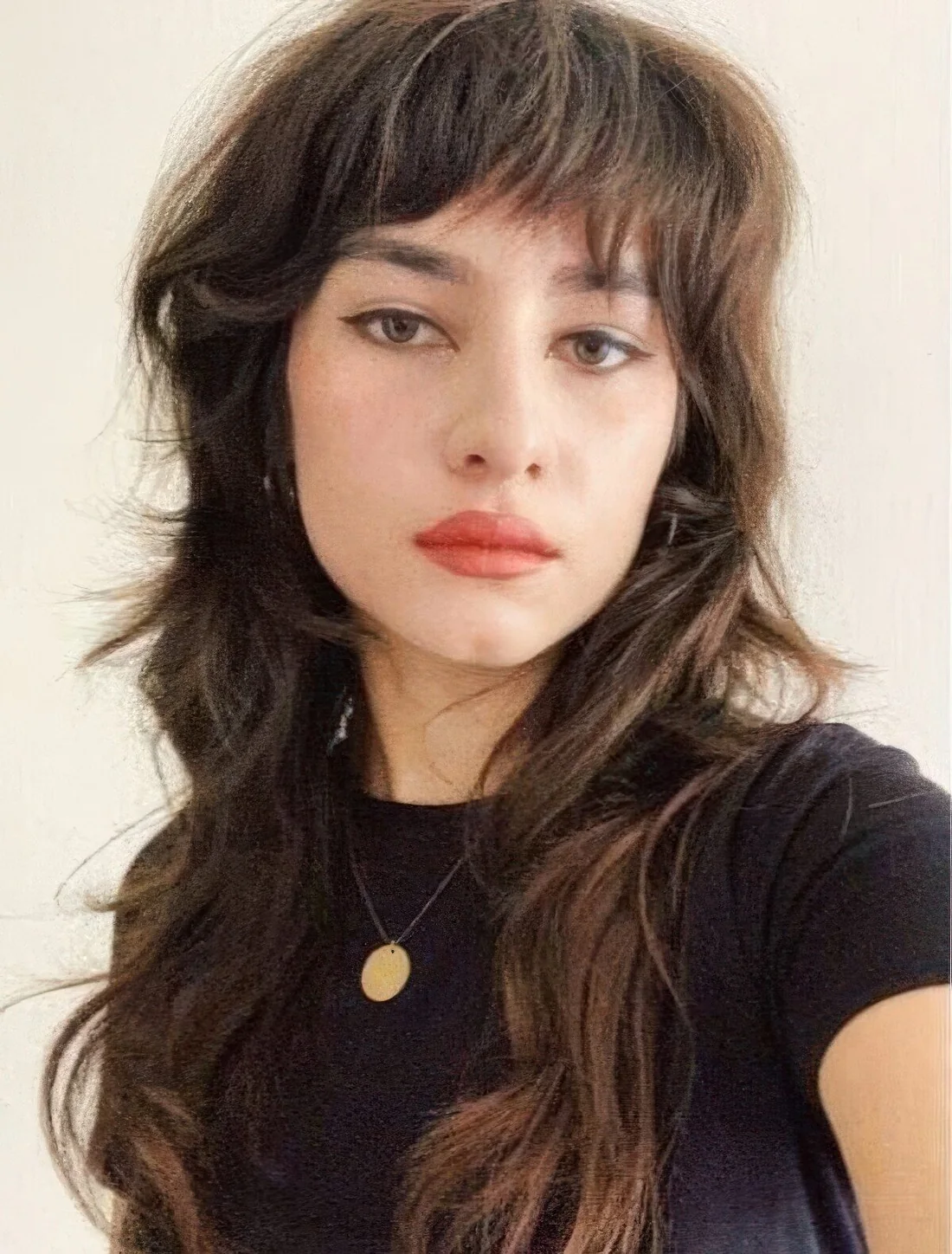 Wolf cut with textured and messy bangs and long tiers.