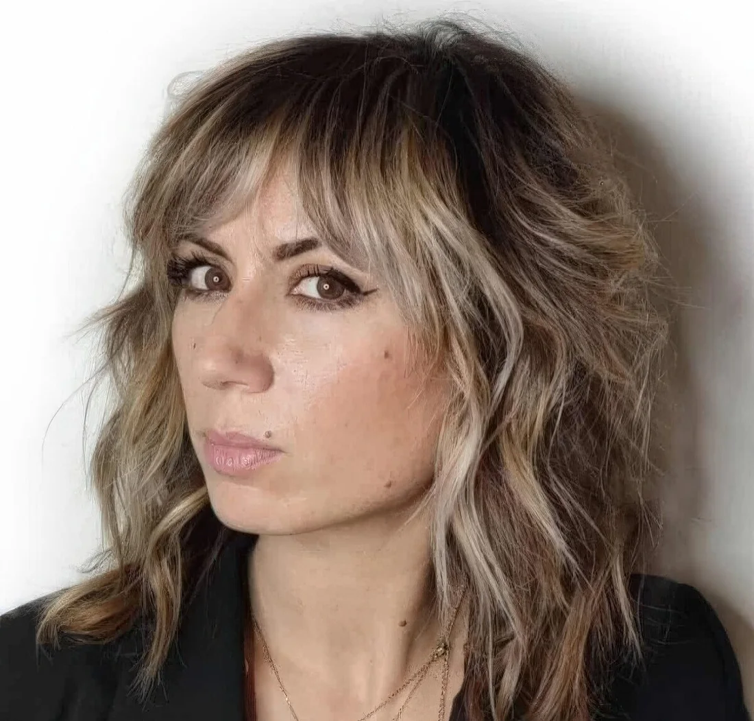 Ashy blonde balayage softens the wolf cut haircut and produces a modern look that.