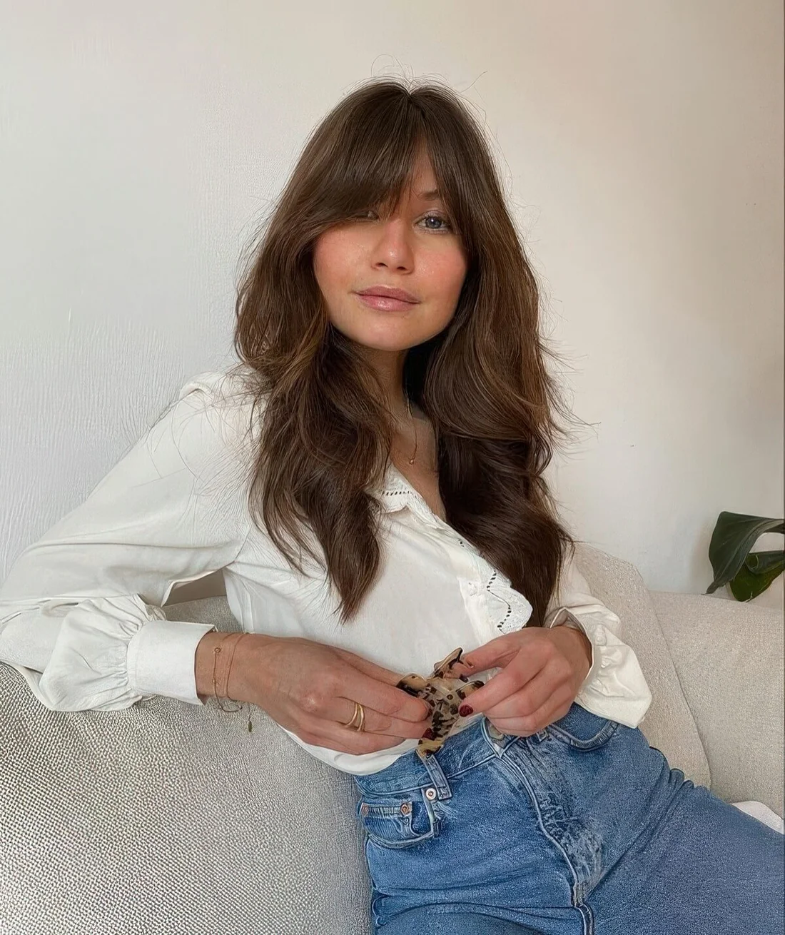 Long brunette wolf cut with camaral balayage and bottleneck bangs.