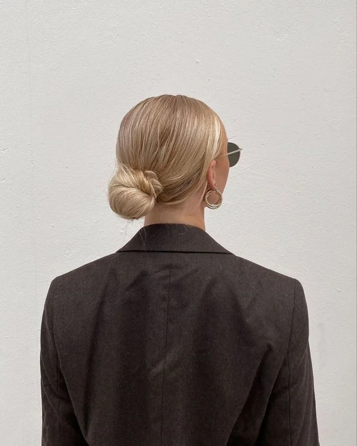Photo showing low sleek bun, with the hairstyle clearly visible.
