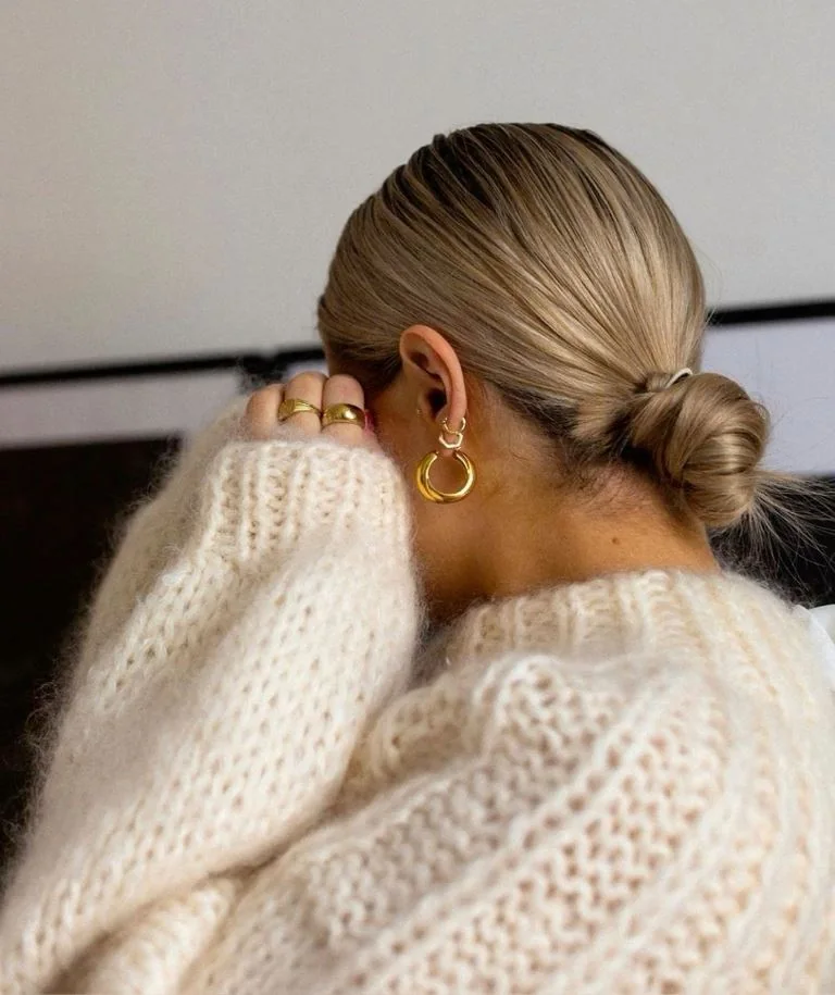 Photo showing messy low bun, with the hairstyle clearly visible.