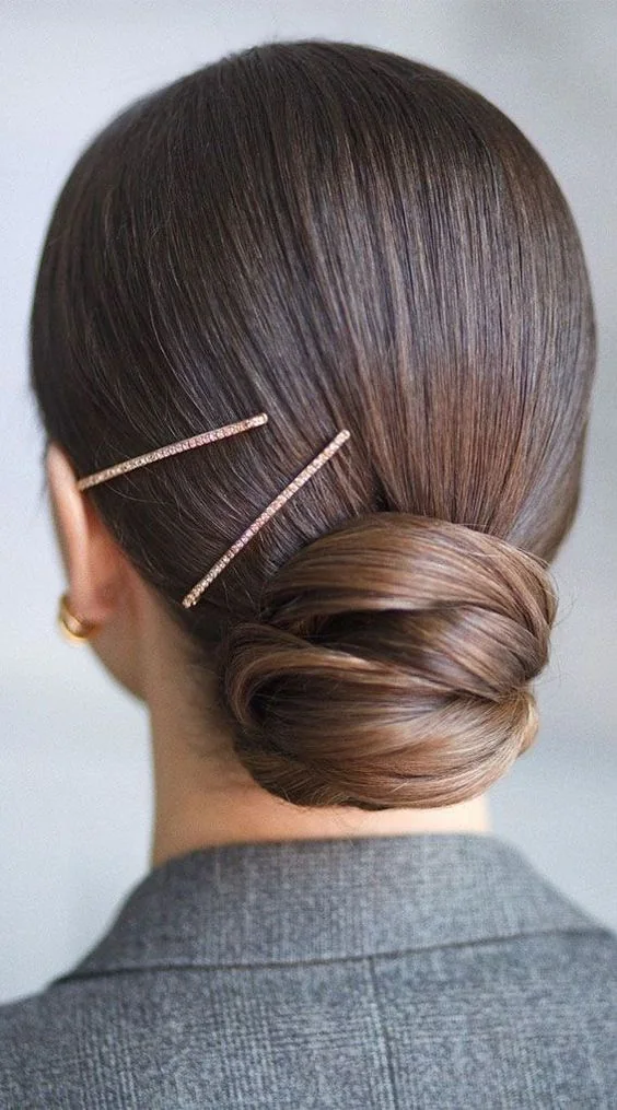 Photo showing low bun hair pins, with the hairstyle clearly visible.