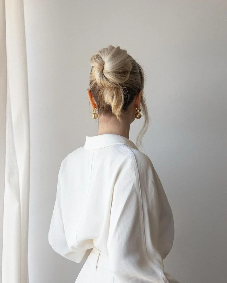 Photo showing midi messy ballerina bun, with the hairstyle clearly visible.